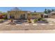 Inviting single-story home featuring xeriscape landscaping, mature trees, and stone walkway at 4233 W Michigan Ave, Glendale, AZ 85308