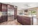 An updated kitchen features dark cabinetry, stainless steel appliances, and a granite island at 4233 W Michigan Ave, Glendale, AZ 85308