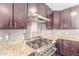 Close-up of a modern kitchen with stainless steel appliances, granite countertops, and custom cabinetry at 4233 W Michigan Ave, Glendale, AZ 85308