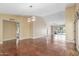 Open-concept living area with modern lighting, neutral color palette, and access to additional rooms at 4233 W Michigan Ave, Glendale, AZ 85308