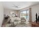 Relaxing main bedroom with ceiling fan, hardwood floors, and view of the pool at 4233 W Michigan Ave, Glendale, AZ 85308