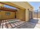 Covered patio with stone flooring, shaded pergola, and access to the garage at 4233 W Michigan Ave, Glendale, AZ 85308