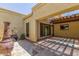 Covered patio with stone flooring, shaded pergola, and outdoor decor accents at 4233 W Michigan Ave, Glendale, AZ 85308