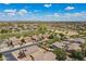 Scenic aerial view of a well-maintained neighborhood with lush landscaping and a beautiful golf course at 43612 W Chambers Ct, Maricopa, AZ 85138