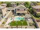 Expansive aerial view of a home featuring a pool, lush lawn, and outdoor seating in a well-maintained community at 43612 W Chambers Ct, Maricopa, AZ 85138