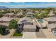 Captivating aerial view of the home and its surrounding neighborhood with mountain views, pool and backyard oasis at 43612 W Chambers Ct, Maricopa, AZ 85138