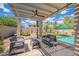 Seating area featuring pergola near the pool in the backyard at 43612 W Chambers Ct, Maricopa, AZ 85138