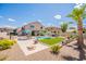 Landscaped backyard with patio, pool, synthetic grass, and desert flora at 43612 W Chambers Ct, Maricopa, AZ 85138
