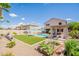 Expansive backyard featuring a pool, turf area, pergola, and lush landscaping at 43612 W Chambers Ct, Maricopa, AZ 85138
