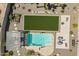 Aerial view of the backyard featuring a sparkling pool, green lawn, and outdoor lounge area at 43612 W Chambers Ct, Maricopa, AZ 85138