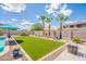 Beautiful backyard featuring lush artificial grass, perfect for recreation and relaxation with meticulously maintained landscaping at 43612 W Chambers Ct, Maricopa, AZ 85138