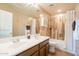 A bathroom with a double sink vanity, tiled floors, and a shower-tub combination at 43612 W Chambers Ct, Maricopa, AZ 85138