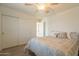 Neutral bedroom featuring a ceiling fan, carpet, and large closet at 43612 W Chambers Ct, Maricopa, AZ 85138