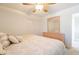 Comfortable bedroom with neutral tones, ceiling fan, and sliding door closet at 43612 W Chambers Ct, Maricopa, AZ 85138