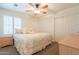 Cozy bedroom with a queen-size bed, soft lighting, and a sliding door closet at 43612 W Chambers Ct, Maricopa, AZ 85138