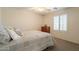 Bright bedroom with a comfortable bed, neutral tones, and a three drawer dresser at 43612 W Chambers Ct, Maricopa, AZ 85138
