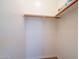 Bright, empty closet with a wooden shelf and rod, ready for storage solutions and organizational potential at 43612 W Chambers Ct, Maricopa, AZ 85138