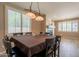 Dining room with shuttered windows and a decorative lighting fixture at 43612 W Chambers Ct, Maricopa, AZ 85138