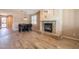 Open-concept dining area featuring a fireplace and wood-look tile flooring at 43612 W Chambers Ct, Maricopa, AZ 85138