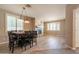 Formal dining room with fireplace and modern chandelier lighting at 43612 W Chambers Ct, Maricopa, AZ 85138
