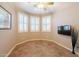 Empty room with tile flooring, plantation shutters, and TV mount at 43612 W Chambers Ct, Maricopa, AZ 85138