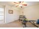 Bright exercise room with equipment, ceiling fan, and access to natural light at 43612 W Chambers Ct, Maricopa, AZ 85138