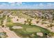 Picturesque aerial view showcasing the golf course surrounded by beautiful desert landscape at 43612 W Chambers Ct, Maricopa, AZ 85138