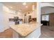 Bright kitchen with granite countertops, stainless steel appliances, and a decorative tile backsplash at 43612 W Chambers Ct, Maricopa, AZ 85138