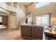Spacious living room featuring a staircase, backyard views, and access to outdoor living at 43612 W Chambers Ct, Maricopa, AZ 85138
