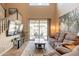 Comfortable living room with tile flooring, backyard views, and a staircase at 43612 W Chambers Ct, Maricopa, AZ 85138