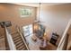 View of the living room and staircase, featuring high ceilings, a ceiling fan, and access to the patio at 43612 W Chambers Ct, Maricopa, AZ 85138
