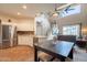 Open living space featuring backyard views and an eat-in kitchen with stainless appliances at 43612 W Chambers Ct, Maricopa, AZ 85138