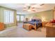 Spacious main bedroom with large windows and ceiling fan at 43612 W Chambers Ct, Maricopa, AZ 85138