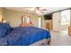 Spacious primary bedroom with a ceiling fan, dresser, and access to an ensuite bathroom at 43612 W Chambers Ct, Maricopa, AZ 85138