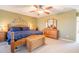 Comfortable bedroom with a ceiling fan and a decorative wall design, creating a relaxing atmosphere at 43612 W Chambers Ct, Maricopa, AZ 85138