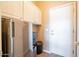 Mud room with a side-by-side refrigerator/water dispenser, cabinet space and access to exterior at 43612 W Chambers Ct, Maricopa, AZ 85138