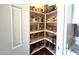 Walk-in pantry with ample shelving space for organized storage of food items and kitchen essentials at 43612 W Chambers Ct, Maricopa, AZ 85138