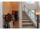 Bright staircase leads up from the entryway, featuring carpeted steps and a convenient storage closet at 43612 W Chambers Ct, Maricopa, AZ 85138