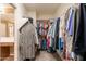 Large walk-in closet with custom shelving, hanging rods, and bonus storage space at 43612 W Chambers Ct, Maricopa, AZ 85138
