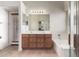 Bathroom boasts a double sink vanity, soaking tub, and neutral tile flooring at 4617 W Alicia Dr, Laveen, AZ 85339