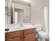 Bathroom with wood vanity, mirror, and shower with bathtub at 4617 W Alicia Dr, Laveen, AZ 85339