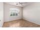 Bedroom area with ceiling fan features neutral tile floor and a shuttered window at 4617 W Alicia Dr, Laveen, AZ 85339