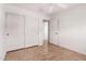 Bright bedroom with tile flooring, ceiling fan, closet, and doorway to another room at 4617 W Alicia Dr, Laveen, AZ 85339