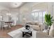 Bright living room featuring neutral tones, large windows, and modern furnishings for a comfortable and stylish space at 4617 W Alicia Dr, Laveen, AZ 85339