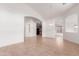 Open living space with tile flooring, neutral walls, and arched entryways leading to the kitchen and dining areas at 4617 W Alicia Dr, Laveen, AZ 85339
