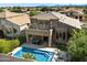 Backyard aerial showcasing the home's pool, spa, patio, and lush landscaping with neighborhood views at 4812 E Daley Ln, Phoenix, AZ 85054