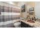 Charming bathroom featuring a decorative sink, stylish vanity, and shower with patterned curtain at 4812 E Daley Ln, Phoenix, AZ 85054