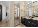 Modern bathroom featuring a sleek glass shower, stylish fixtures, and a granite countertop at 4812 E Daley Ln, Phoenix, AZ 85054