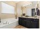 Elegant bathroom with a soaking tub, granite countertop, and stylish fixtures at 4812 E Daley Ln, Phoenix, AZ 85054
