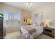 Cozy bedroom featuring soft carpet, a ceiling fan, a window with shutters, and tasteful decorations at 4812 E Daley Ln, Phoenix, AZ 85054